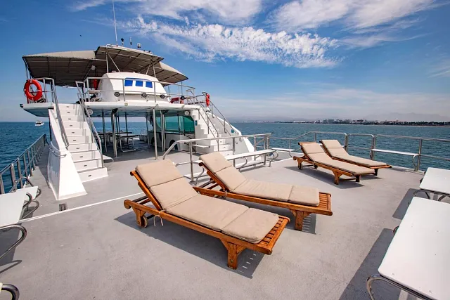 Sun loungers on the deck of a large catamaran